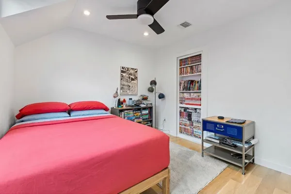 a living room with furniture and a baby crib