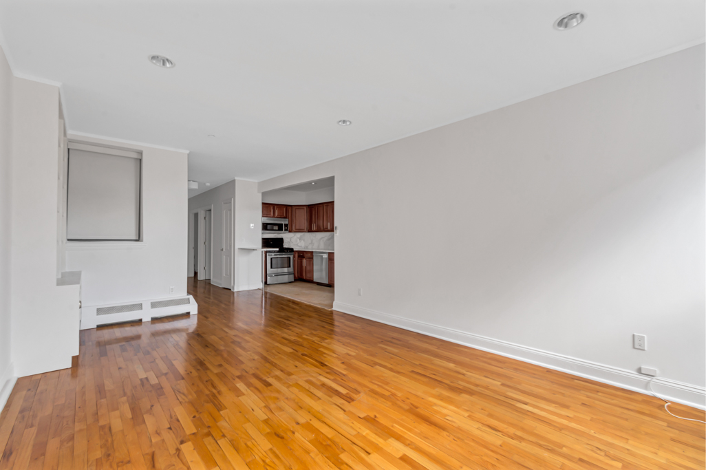2098 Frederick Douglass Boulevard, Unit 5E Manhattan, NY 10026 - Photo 7 of 8 a view of empty room with wooden floor