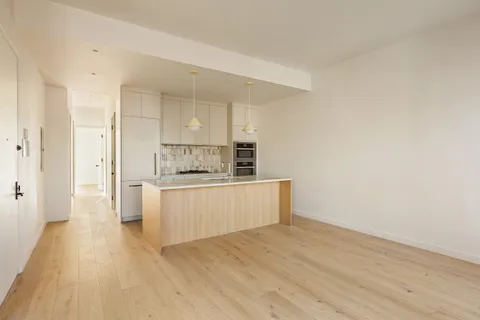 a view of kitchen with wooden floor