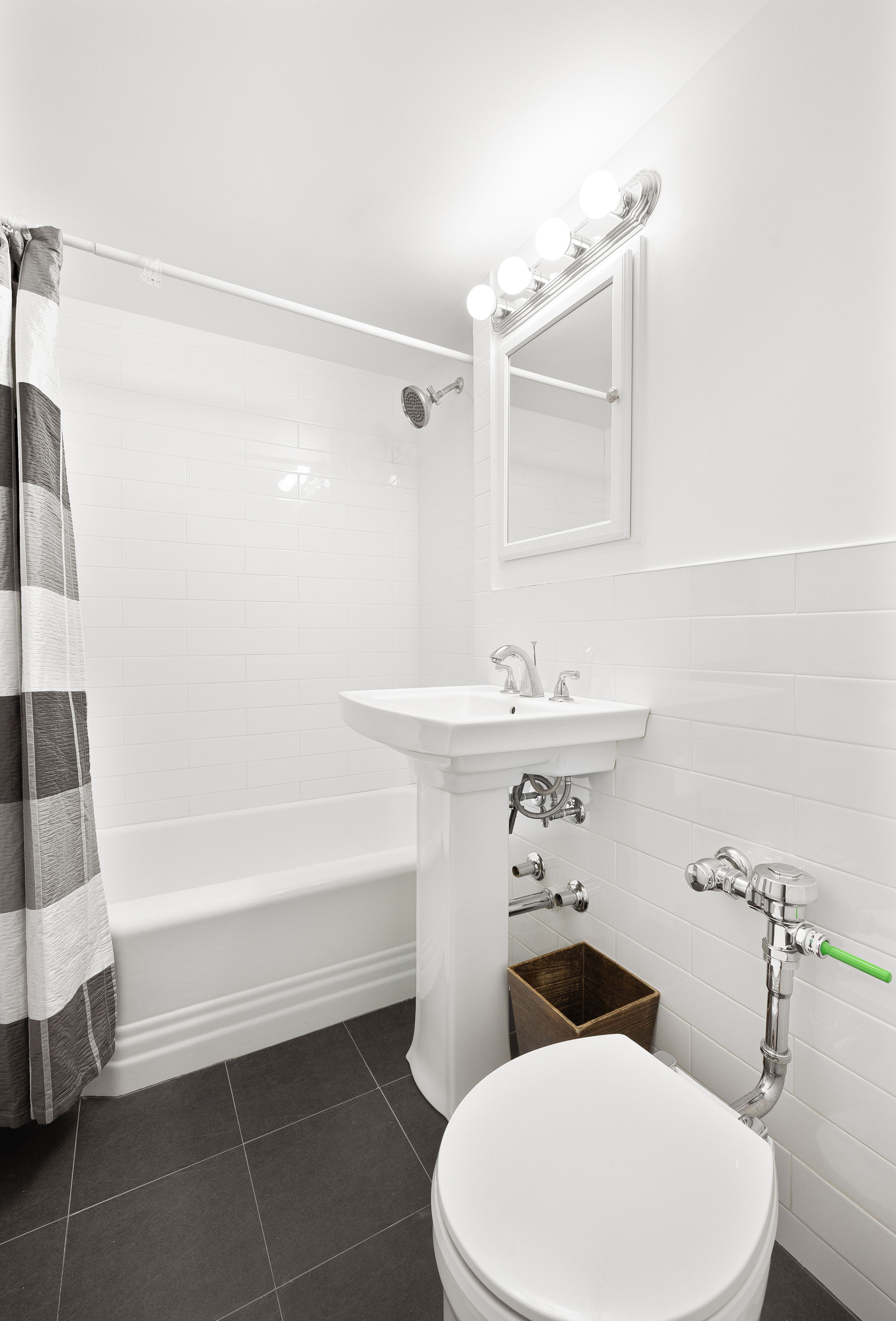 35-11 85th Street, Unit 8M Queens, NY 11372 - Photo 14 of 16 a bathroom with a sink a toilet and shower