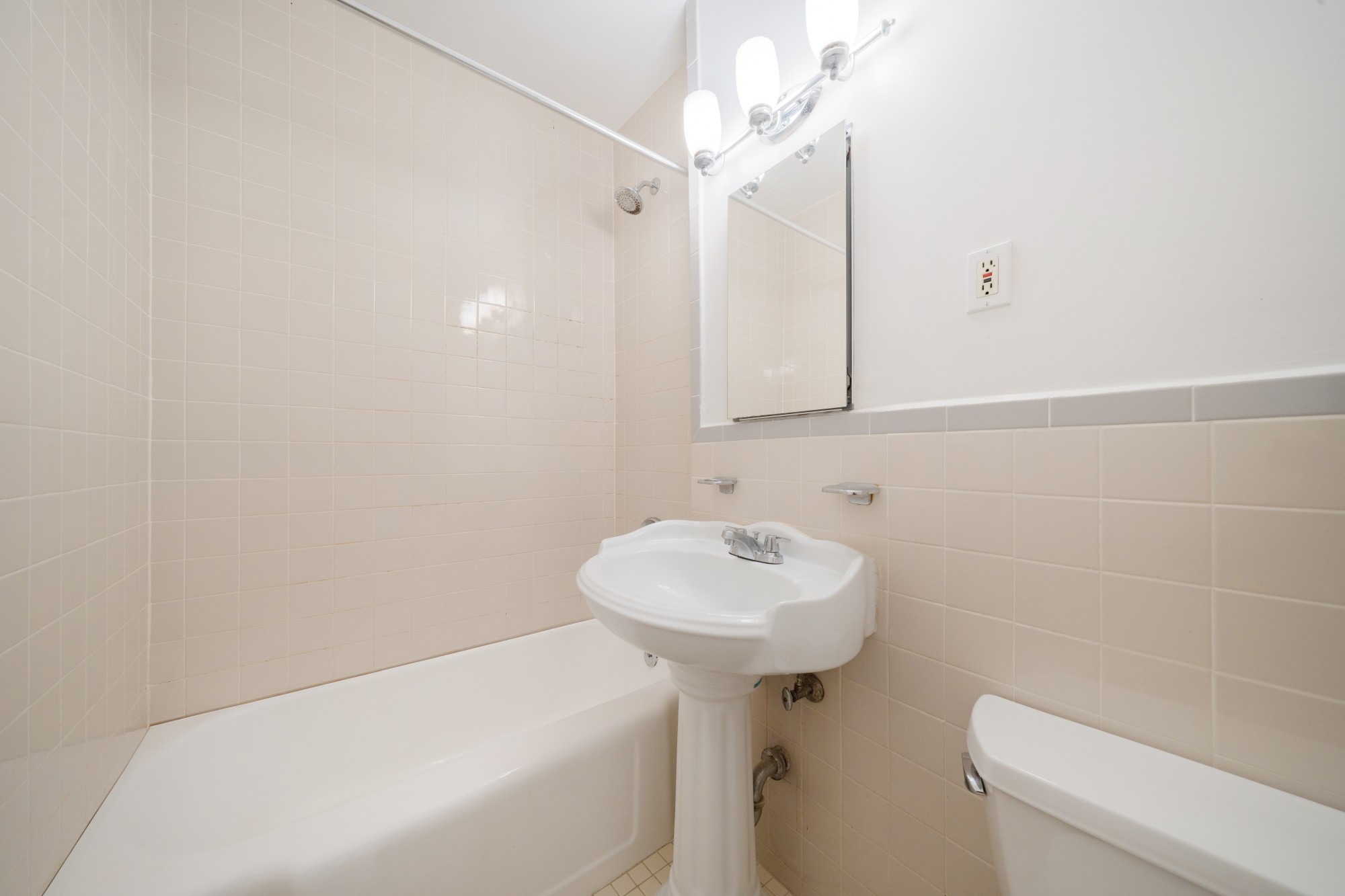 99-52 66th Road, Unit 1H Queens, NY 11374 - Photo 6 of 11 a bathroom with a sink a toilet and mirror