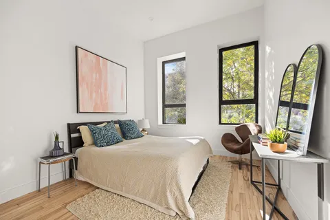 a bedroom with a bed and a large window