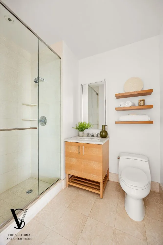 a bathroom with a toilet a sink and shower