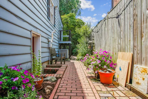 a view of a balcony with flowers potted plants