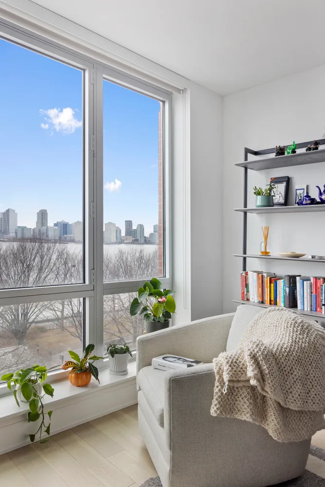 a living room with furniture and a book shelf