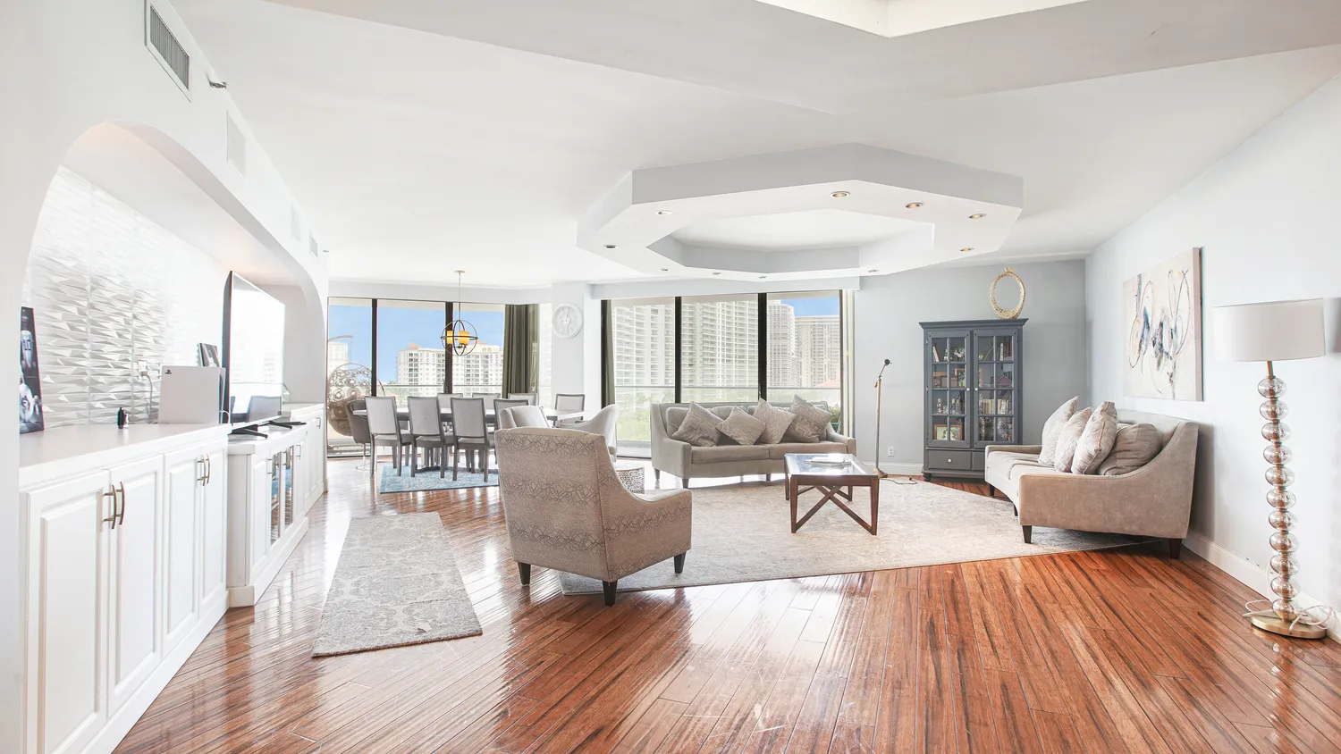 a living room with furniture wooden floor and a rug