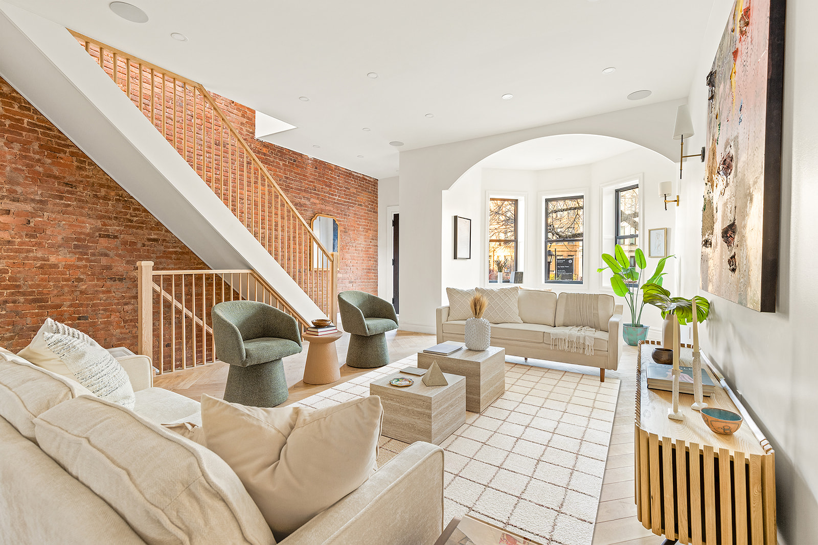 a living room with furniture a fireplace and a large window