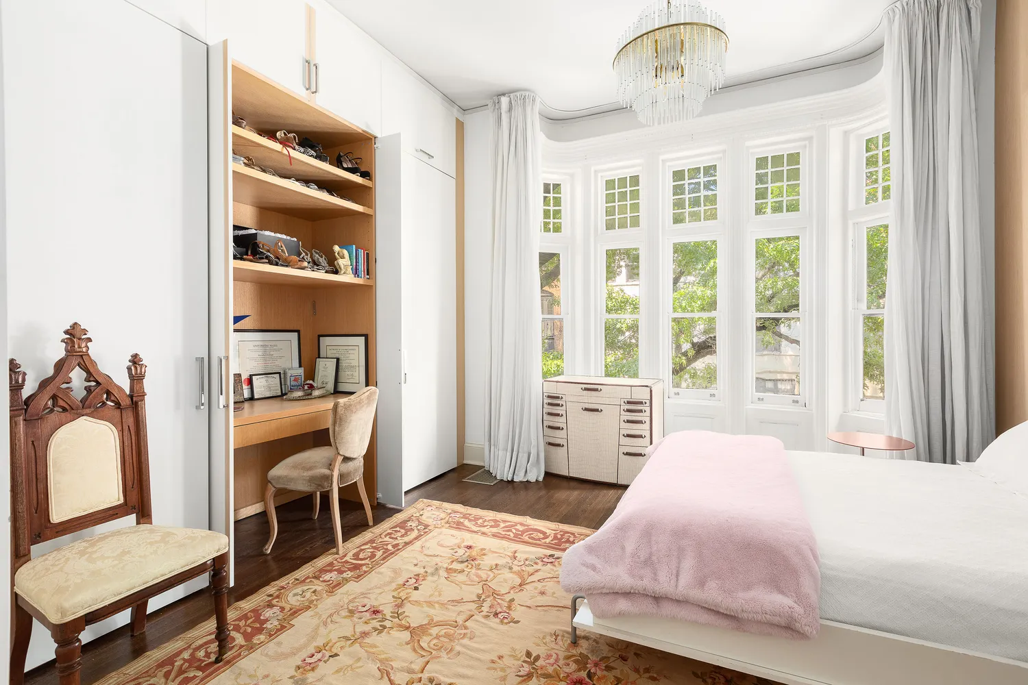 a bedroom with a large bed and a window