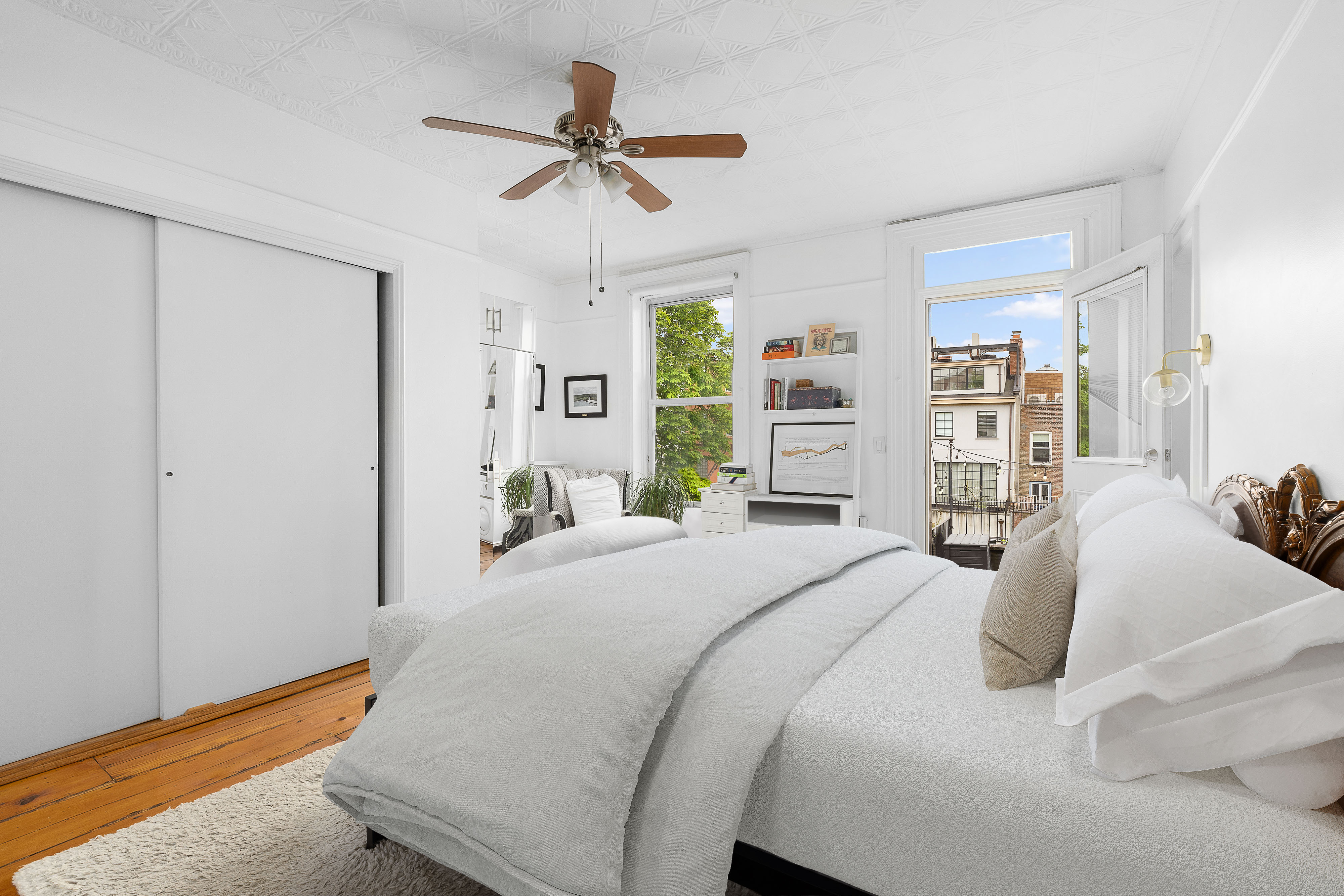 144 Baltic Street Brooklyn, NY 11201 - Photo 8 of 14 a bedroom with a bed and a chandelier