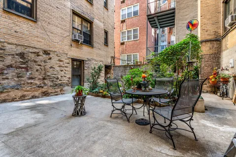 a backyard of a house with table and chairs