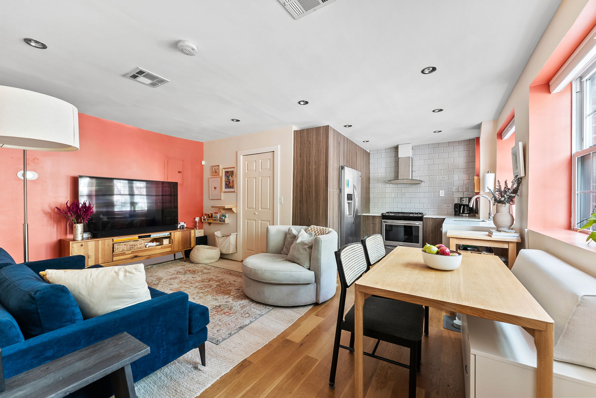 600 Prospect Place, Unit 2 Brooklyn, NY 11238 - Photo 3 of 13 a living room with furniture kitchen view and a flat screen tv