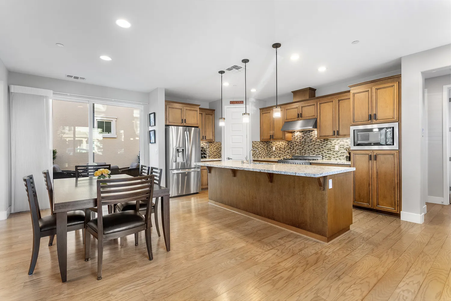 a kitchen with a cabinets and a stove with wooden floor