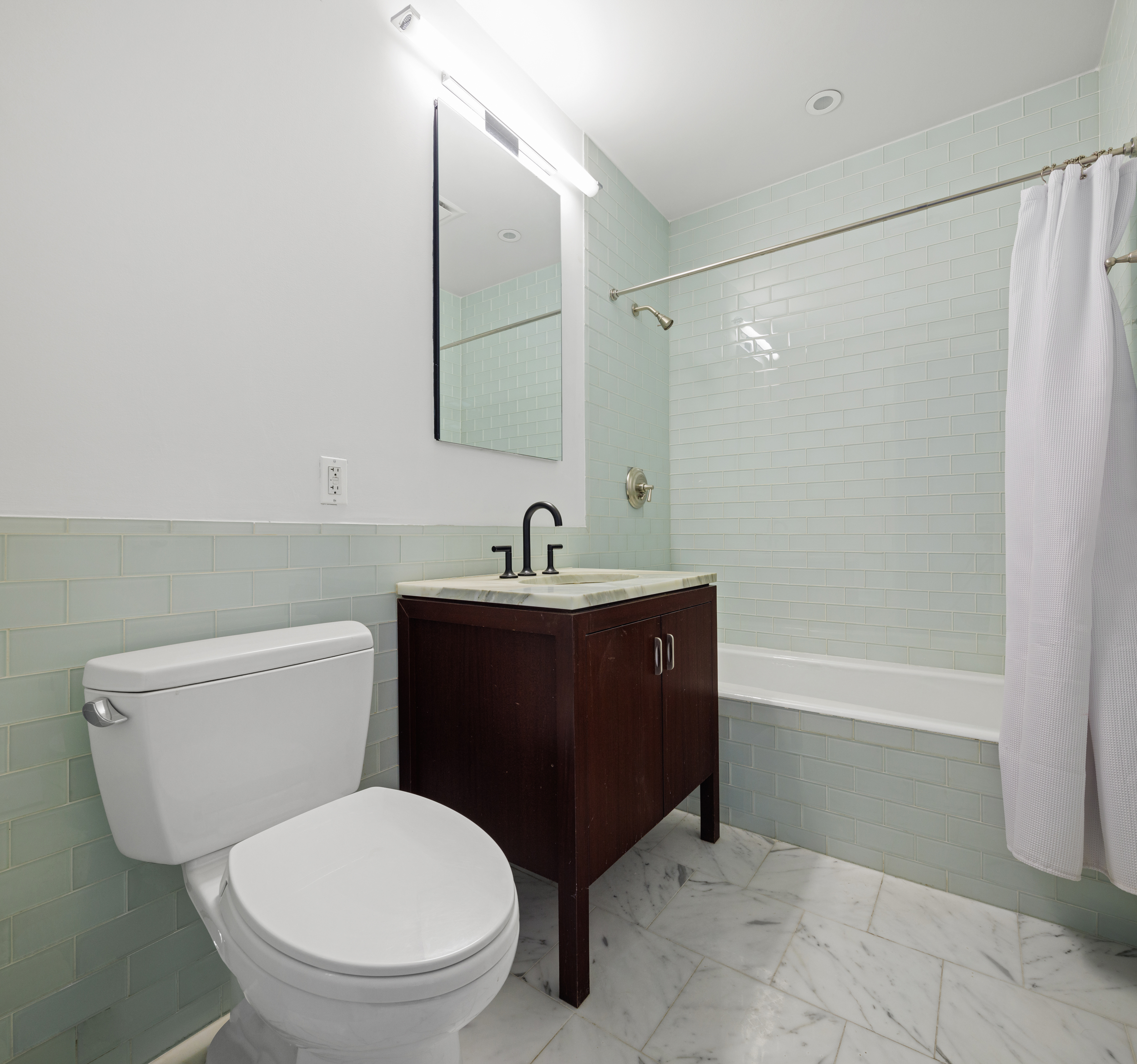 34 Leonard Street, Unit 7A Manhattan, NY 10013 - Photo 8 of 17 a bathroom with a toilet a sink and bathtub