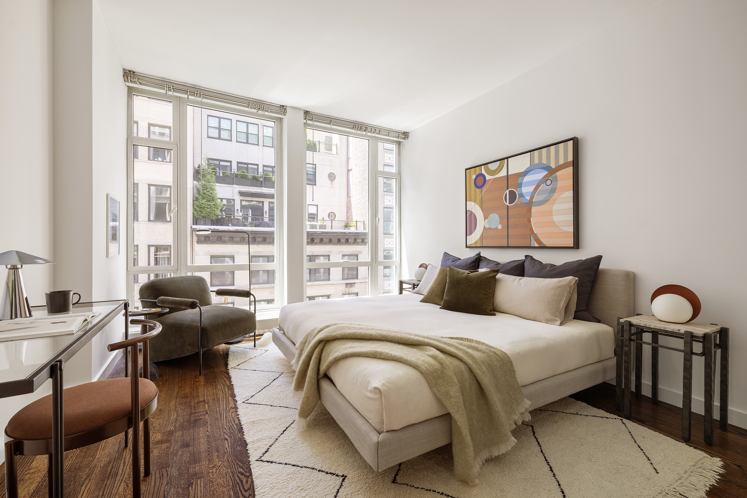 133 West 22nd Street, Unit 8C Manhattan, NY 10011 - Photo 5 of 11 a bedroom with a bed and a couch