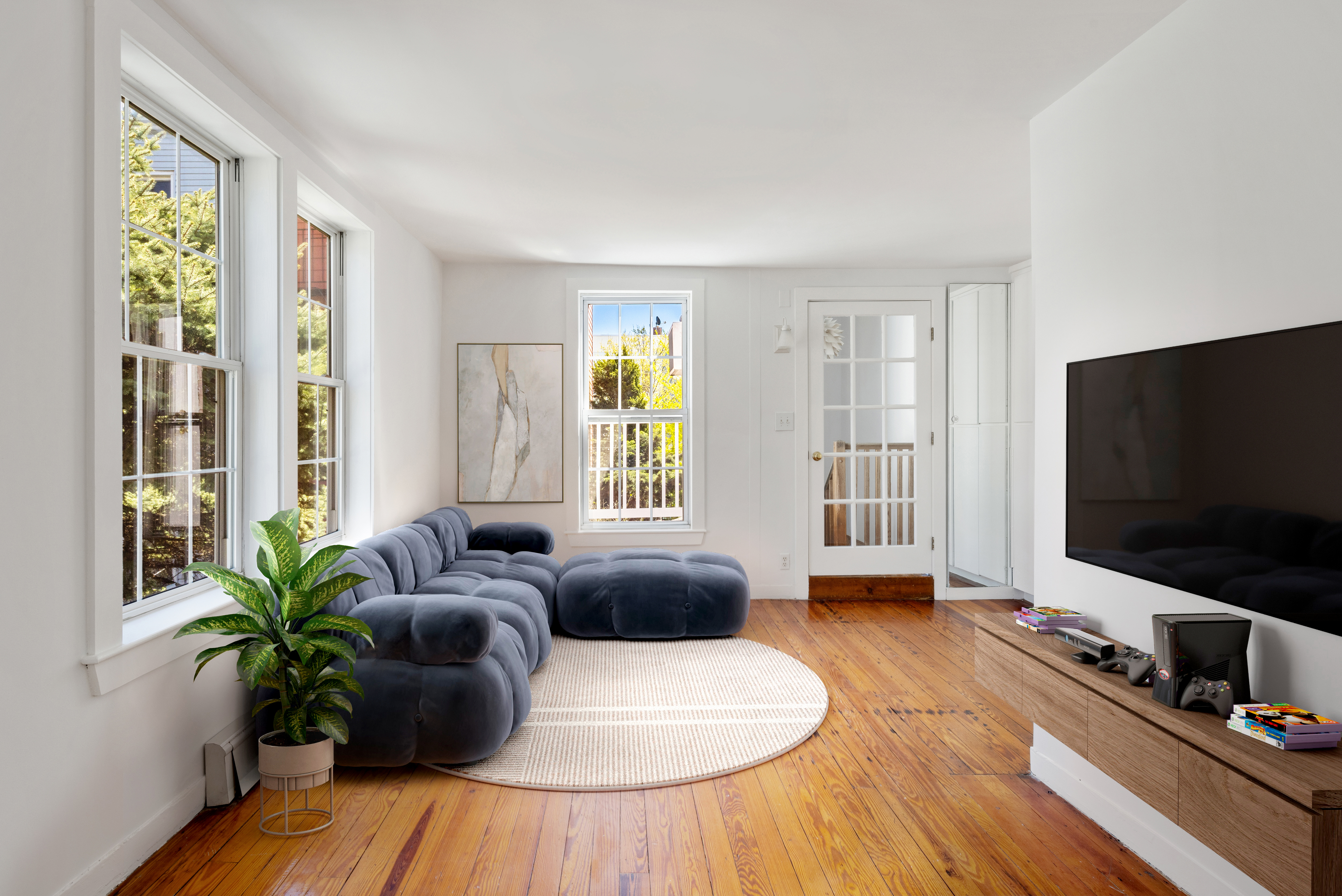 61 Norman Avenue Brooklyn, NY 11222 - Photo 12 of 22 a living room with furniture and a flat screen tv