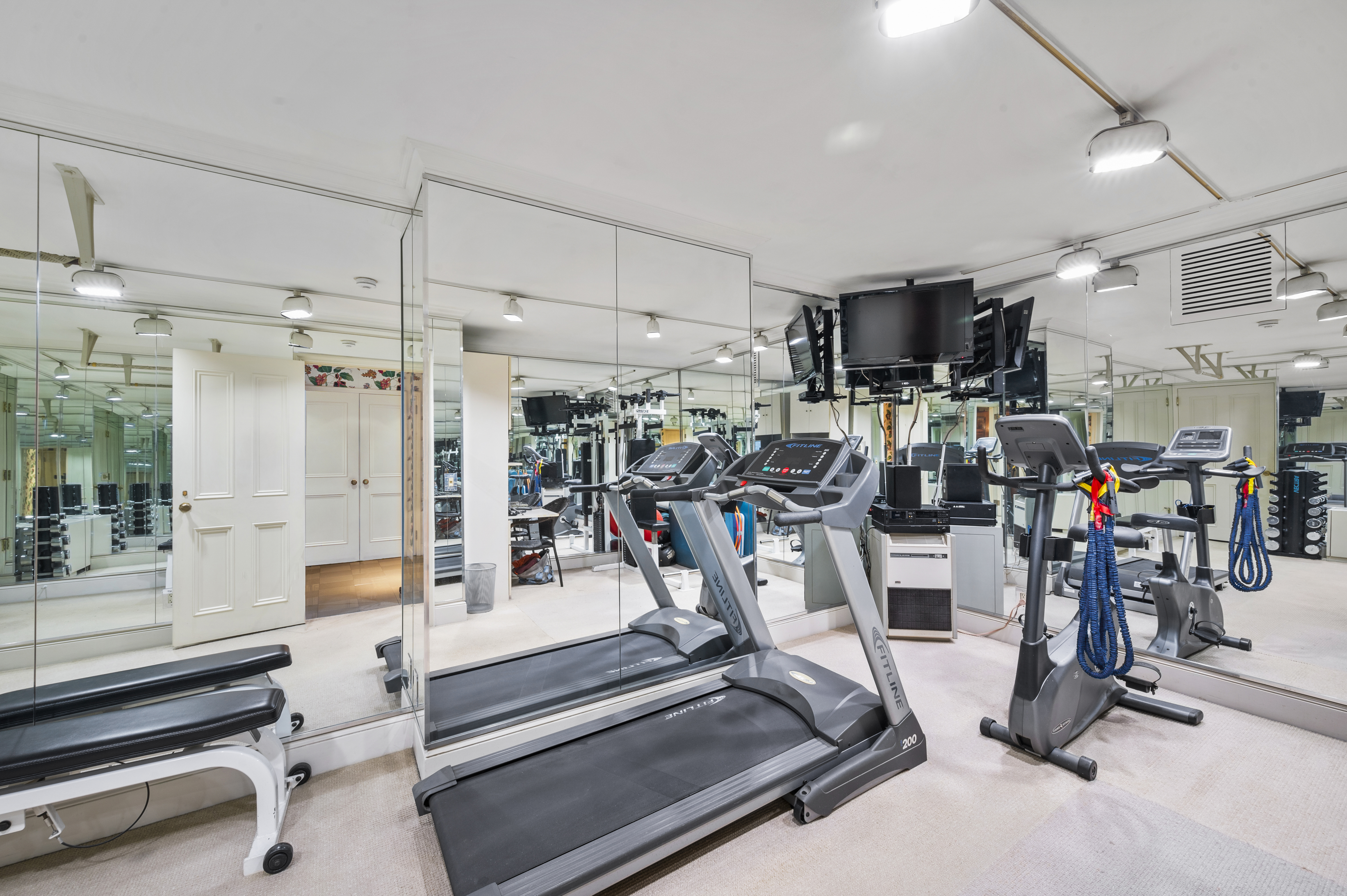 163 East 64th Street Manhattan, NY 10065 - Photo 33 of 34 a view of a room with gym equipment