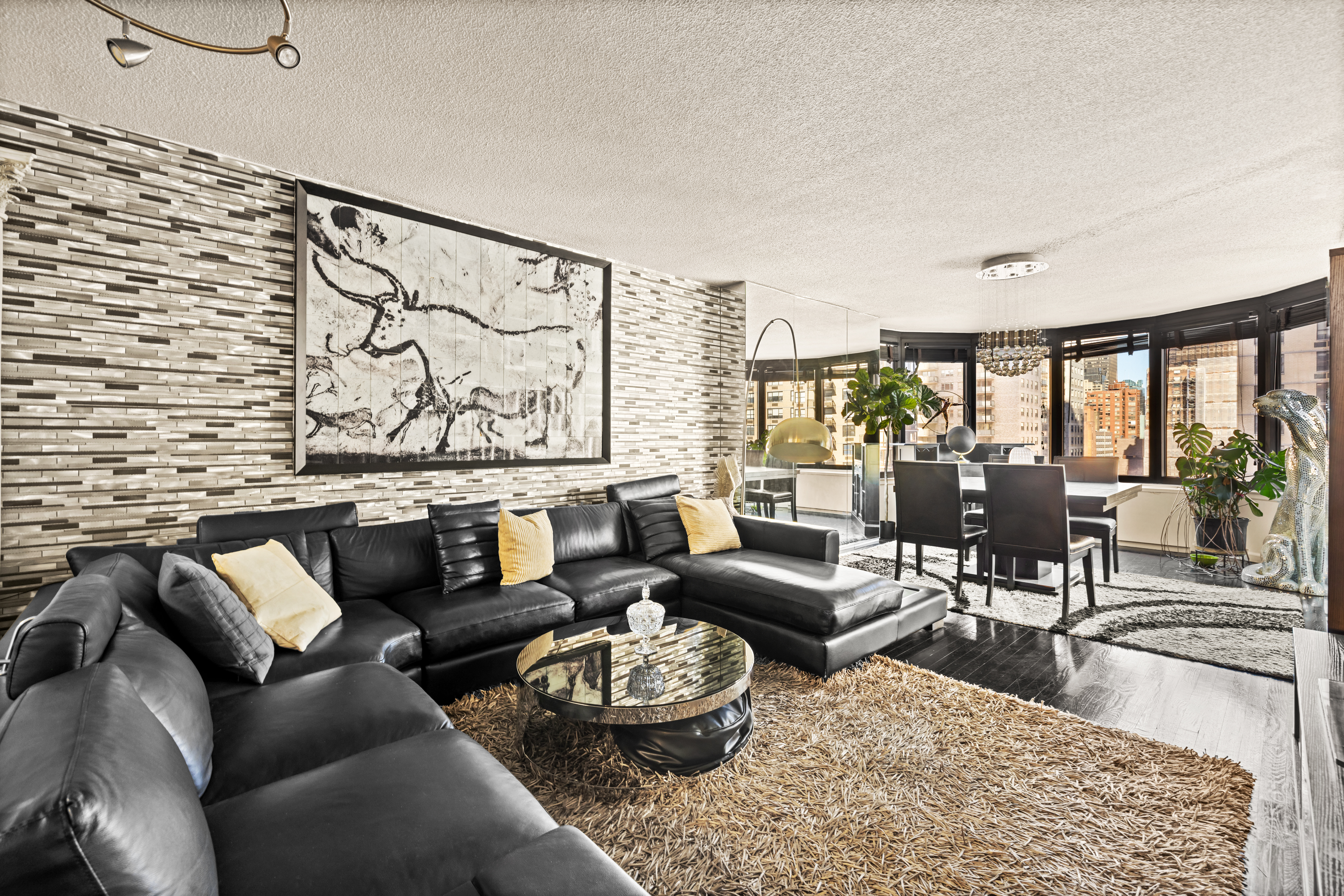 a living room with furniture and a floor to ceiling window