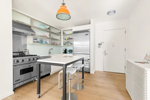 a kitchen with a stove and a refrigerator