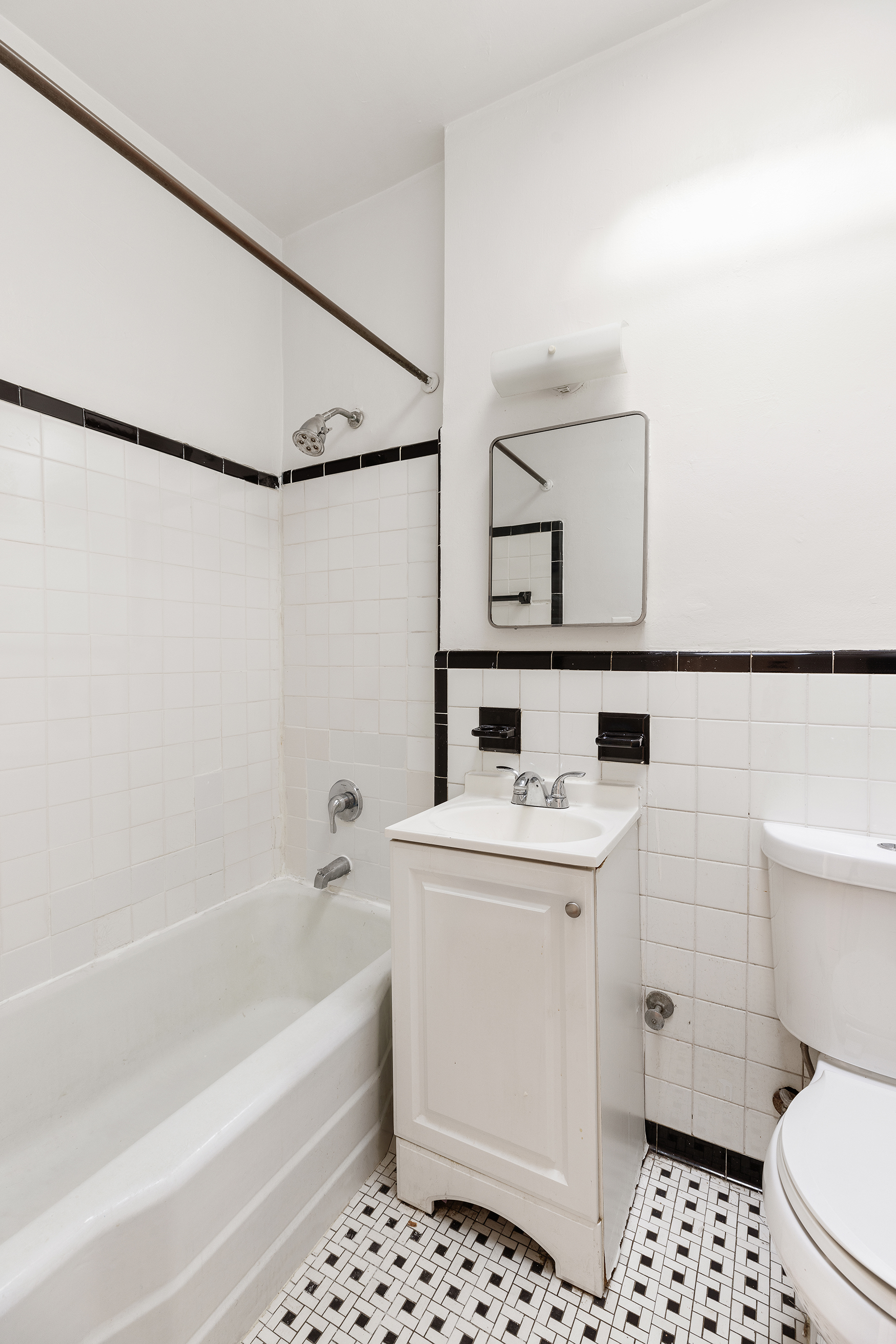 1275 3rd Avenue, Unit 4A Manhattan, NY 10021 - Photo 6 of 8 a bathroom with a sink a toilet and shower