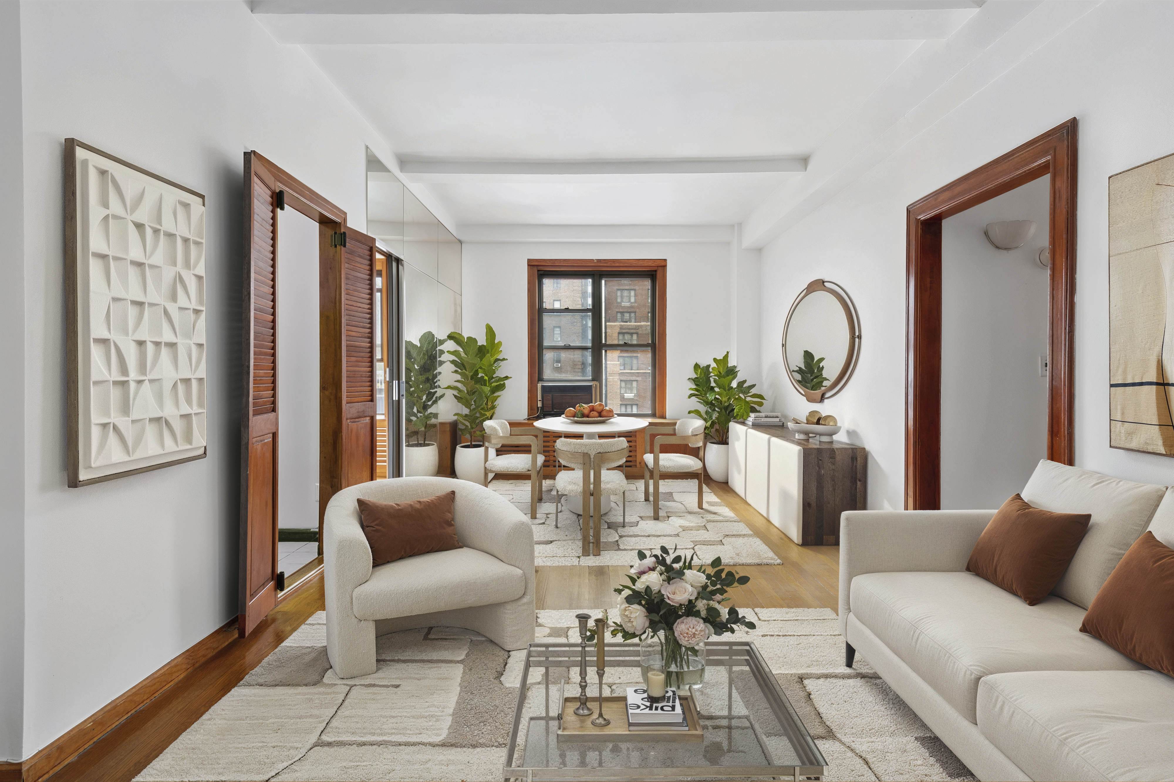 150 East 49th Street, Unit 9D Manhattan, NY 10017 - Photo 6 of 11 a living room with furniture and a large window