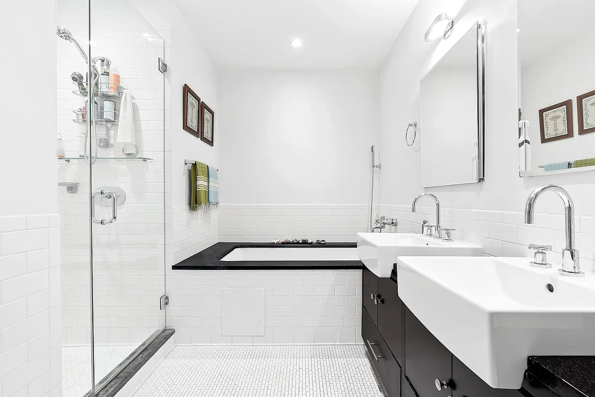110 Livingston Street, Unit 10K Brooklyn, NY 11201 - Photo 2 of 10 a bathroom with a sink and a mirror