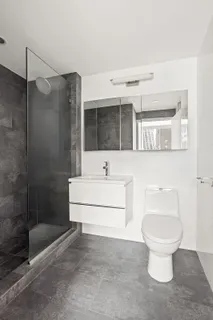 a bathroom with a toilet sink and shower