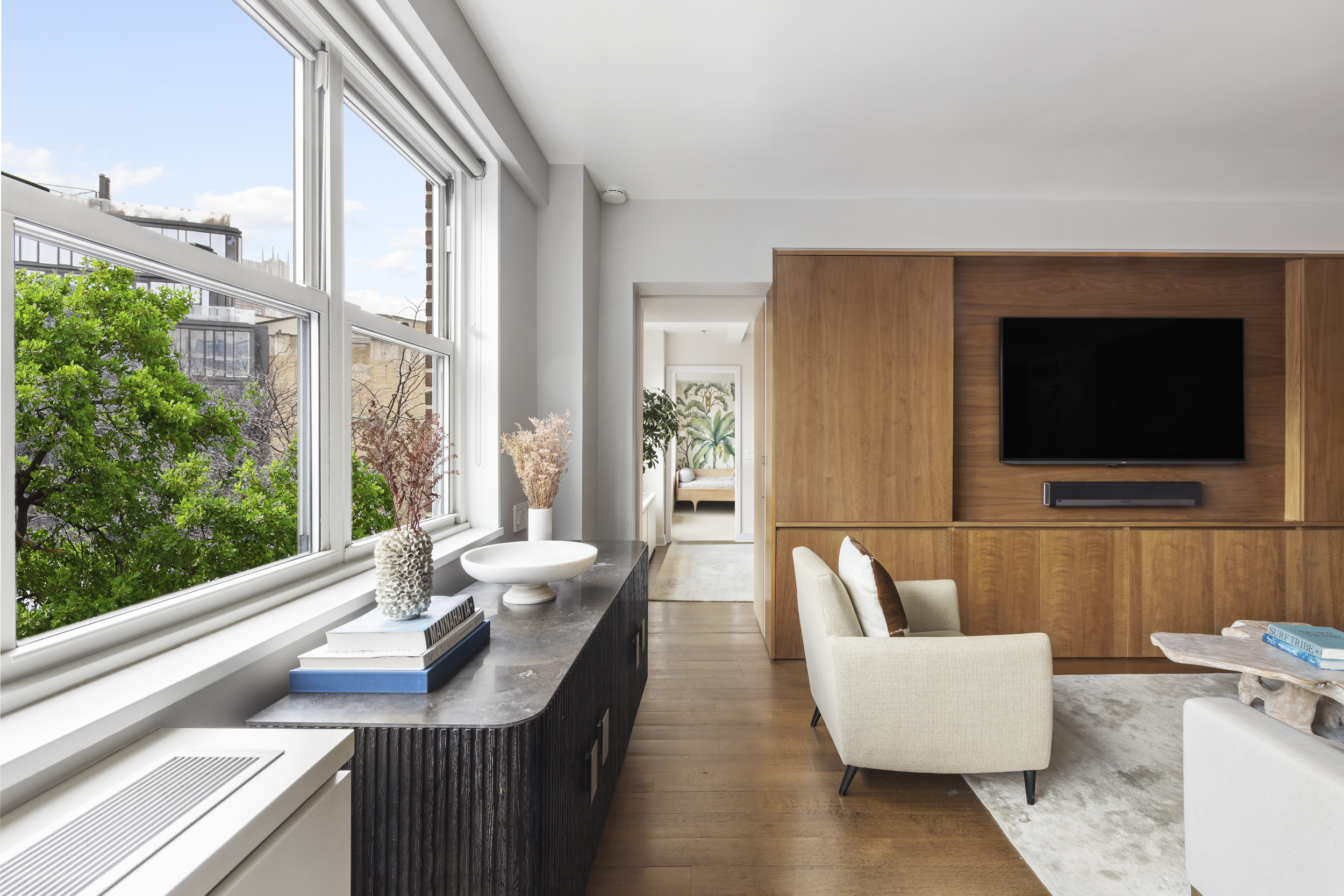 2 Horatio Street, Unit 4JS Manhattan, NY 10014 - Photo 7 of 20 a living room with furniture a flat screen tv and a floor to ceiling window
