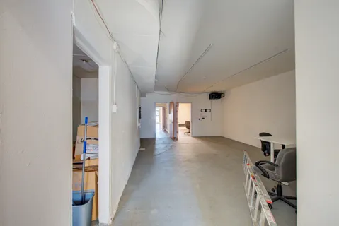 a room with furniture a air conditioner vent and a window