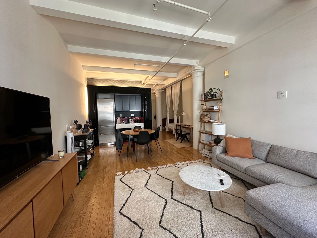 16 West 19th Street, Unit 8B Manhattan, NY 10011 - Photo 3 of 19 a living room with furniture and a flat screen tv
