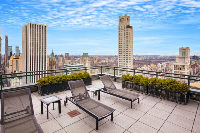 117 East 57th Street, Unit 48G Manhattan, NY 10022 - Photo 10 of 13 a balcony with furniture and city view