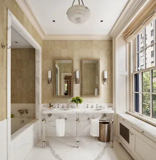 a bathroom with a double vanity sink a toilet a mirror and shower