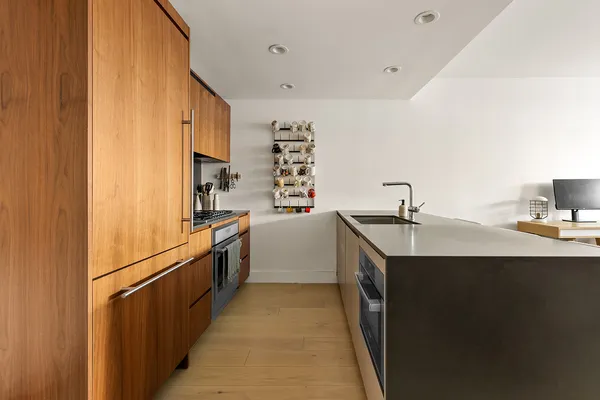 a kitchen with stainless steel appliances granite countertop a table chairs sink and cabinets