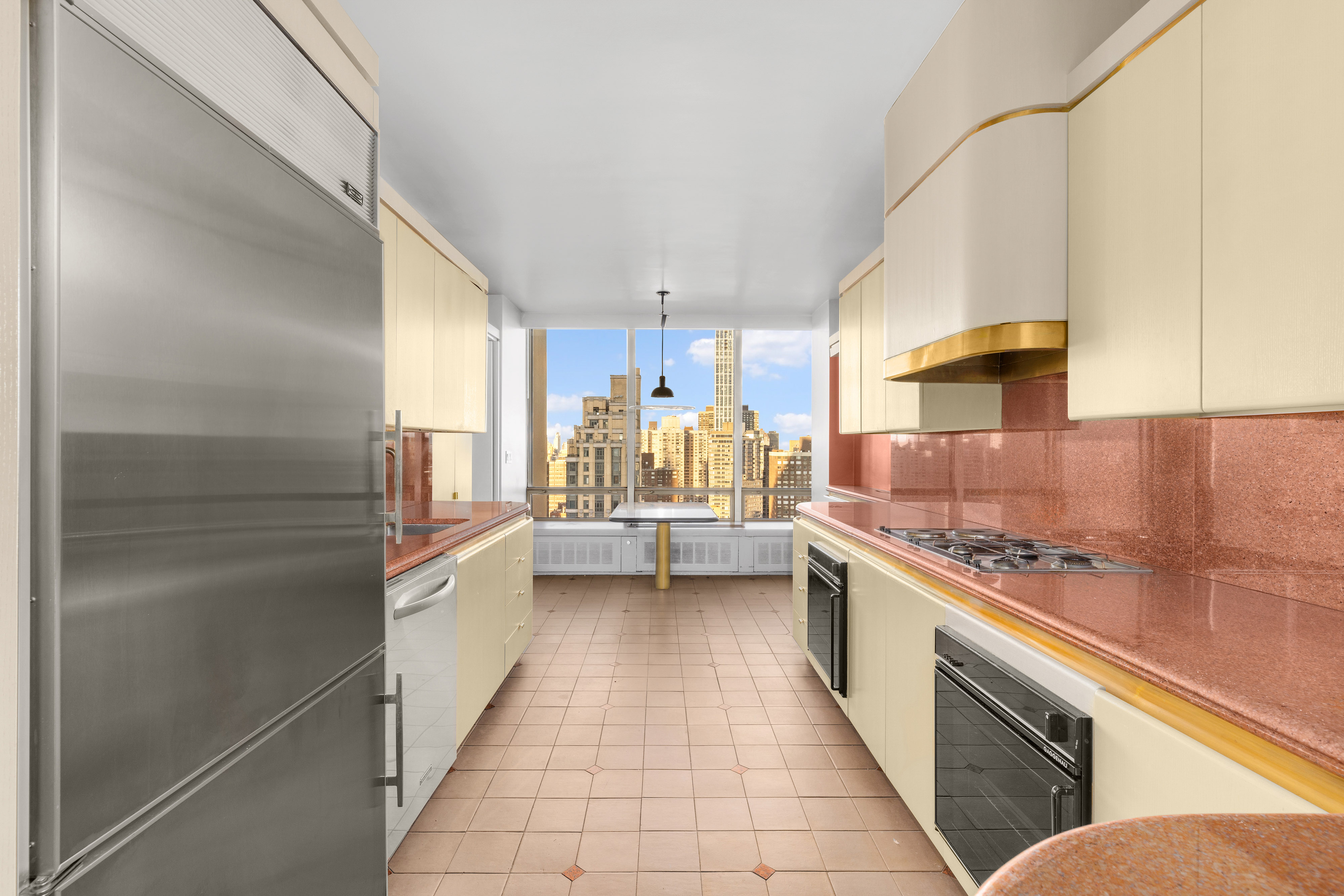 860 United Nations Plaza, Unit 36D Manhattan, NY 10017 - Photo 15 of 21 a kitchen with a sink stove and cabinets