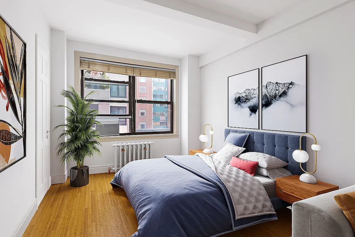 457 West 57th Street, Unit 912 Manhattan, NY 10019 - Photo 2 of 11 a bedroom with a large bed and a large window