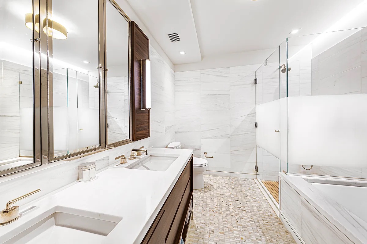 301 East 50th Street, Unit 4B Manhattan, NY 10022 - Photo 6 of 13 a bathroom with a tub sink and mirror