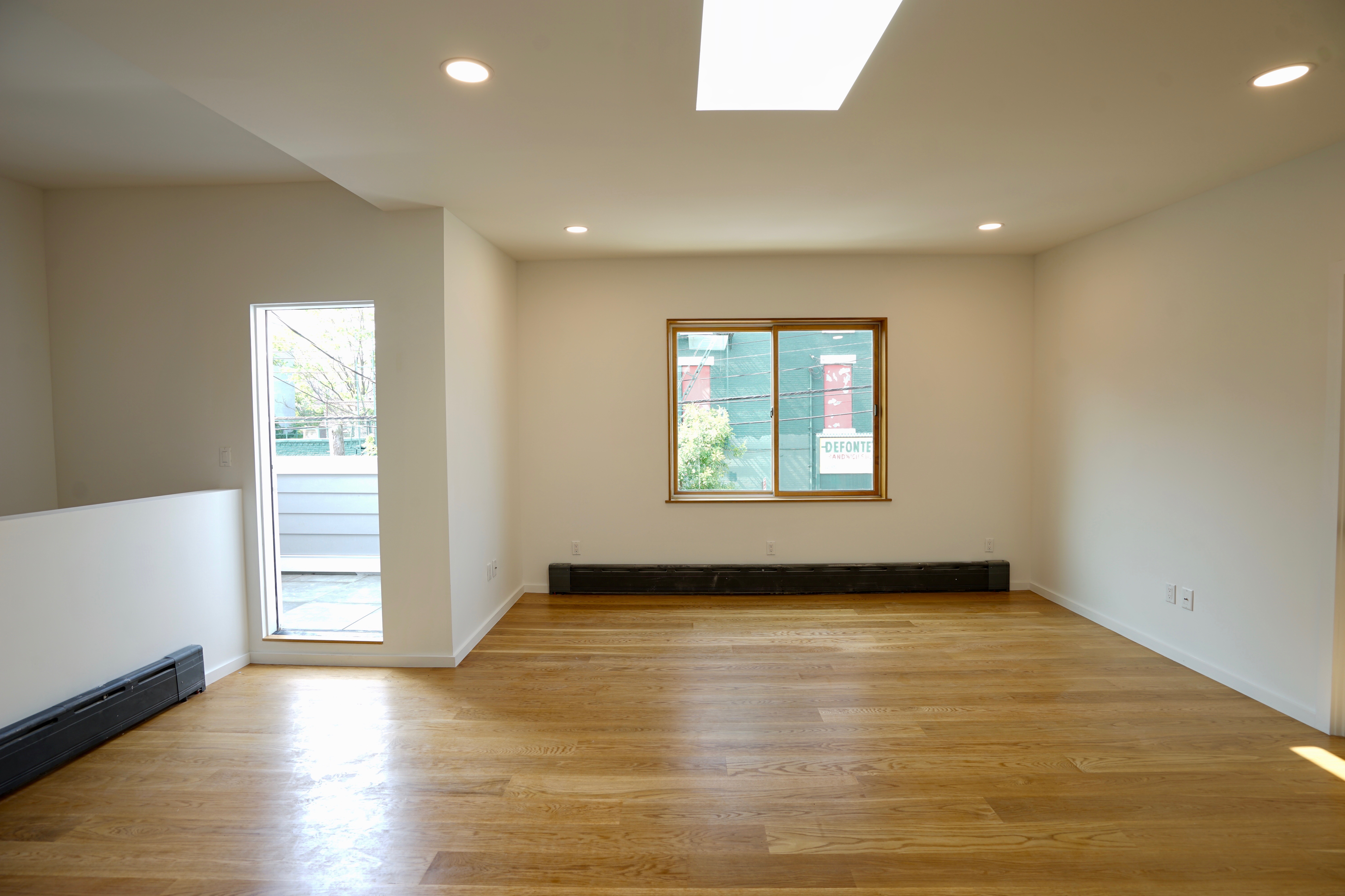 1 Luquer Street, Unit 2 Brooklyn, NY 11231 - Photo 2 of 9 an empty room with wooden floor and windows