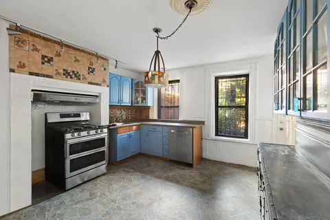 a kitchen with granite countertop a stove oven and sink