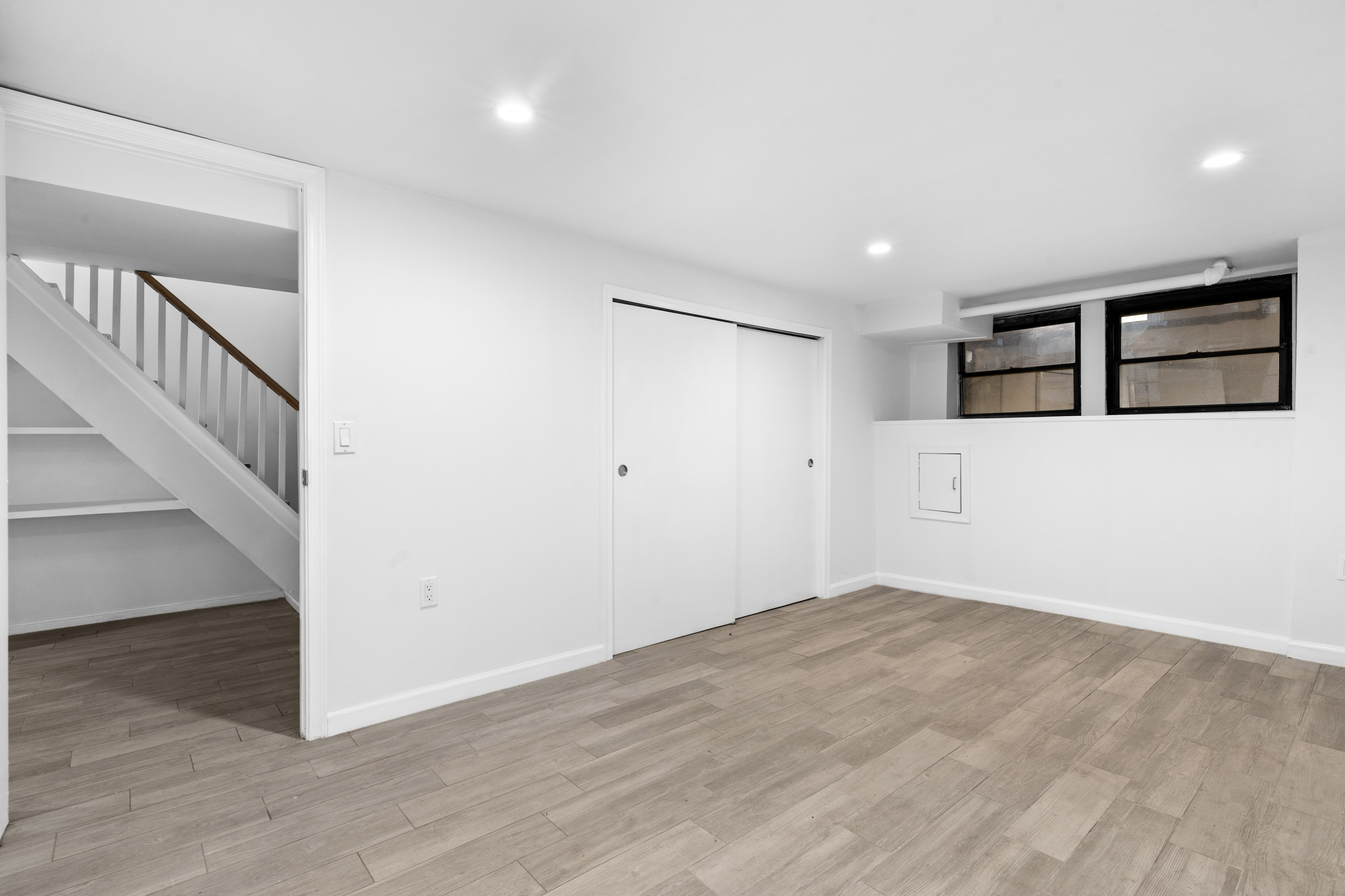 339 East 29th Street Brooklyn, NY 11226 - Photo 16 of 21 a view of an empty room with wooden floor and entryway
