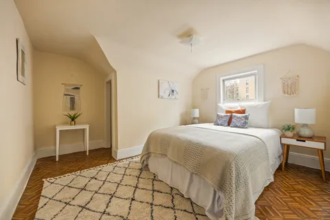 a bedroom with a bed and a table