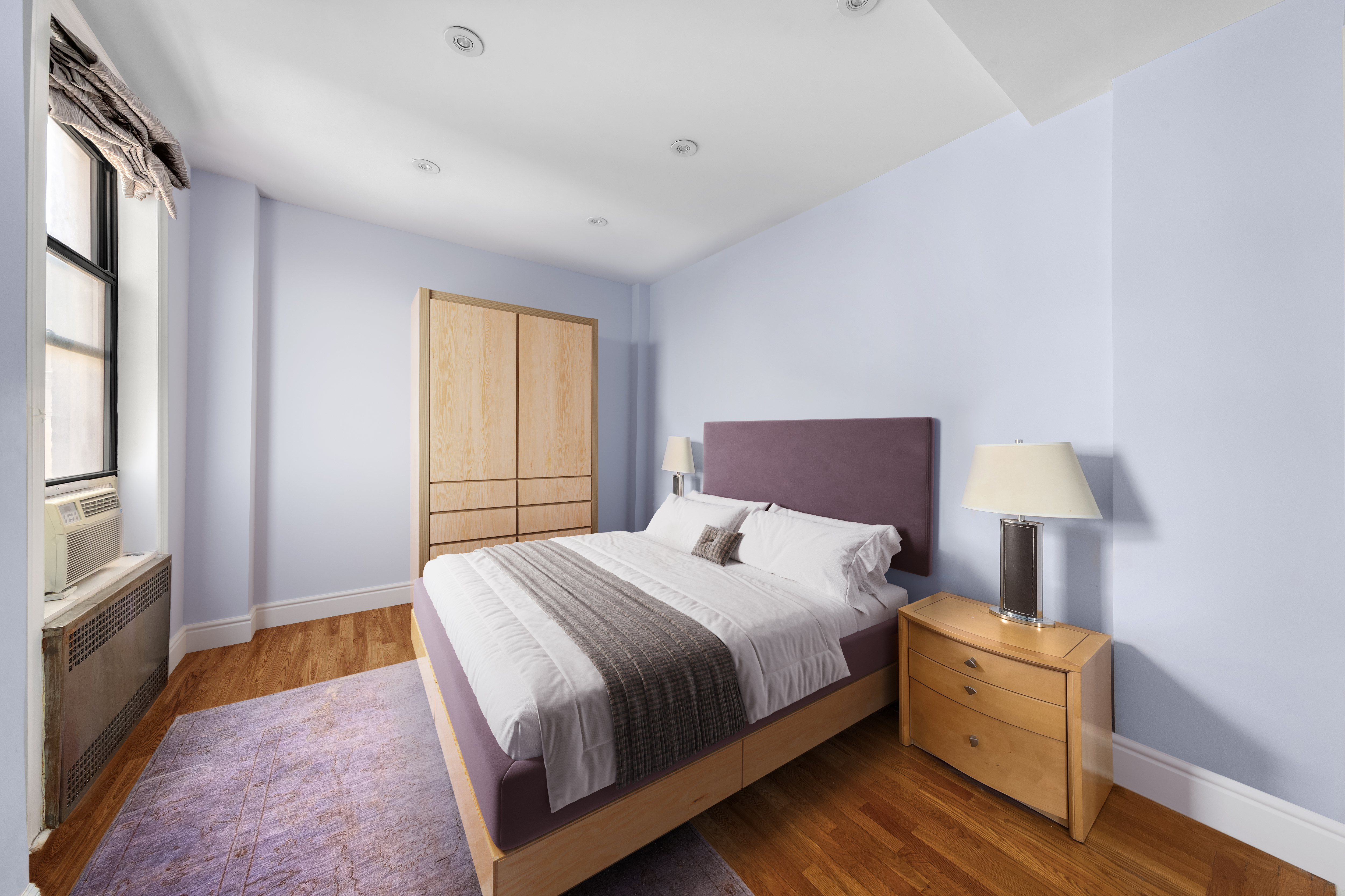 205 West 54th Street, Unit 10E Manhattan, NY 10019 - Photo 6 of 8 a bedroom with a bed and a window