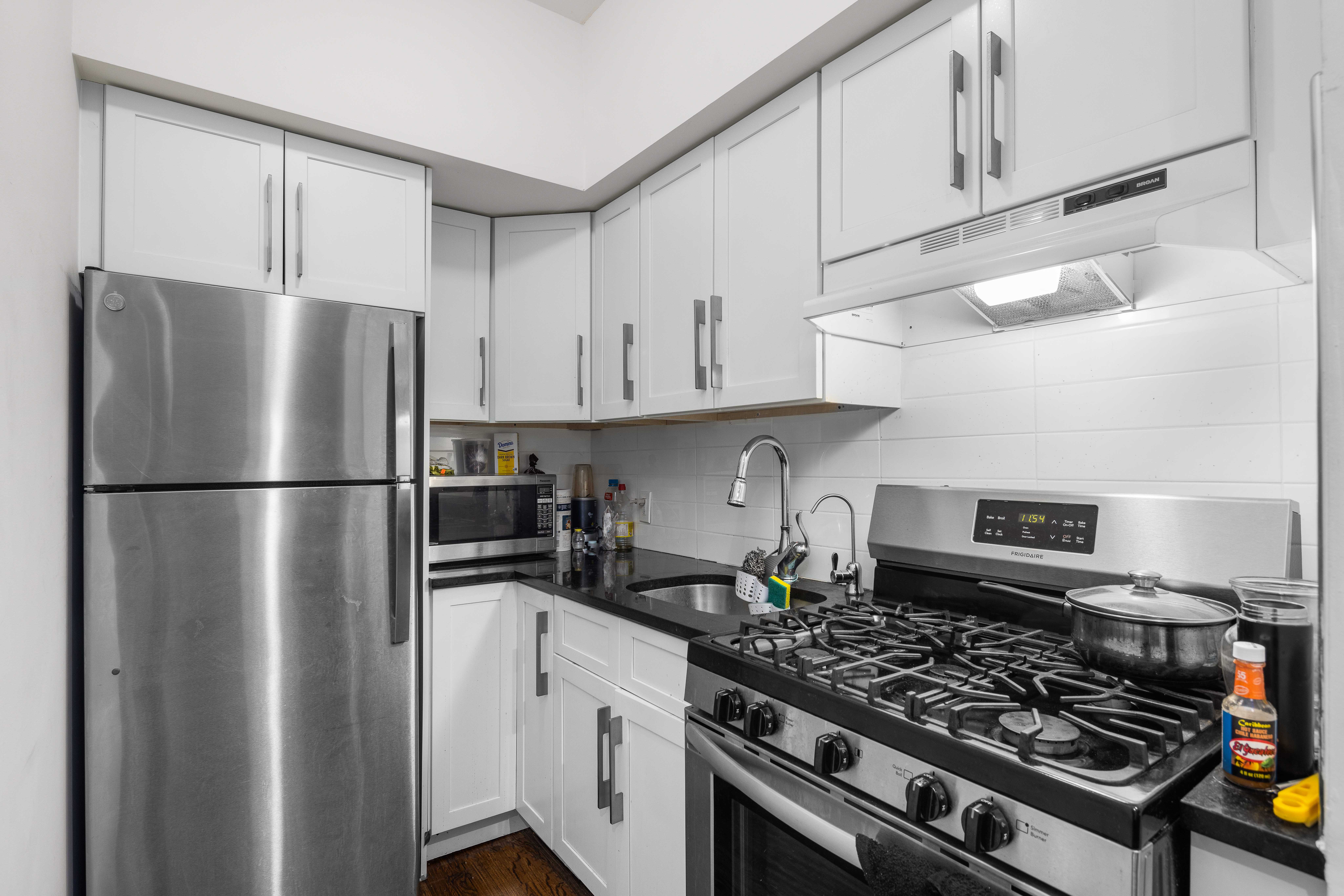 2049 2nd Avenue Manhattan, NY 10029 - Photo 10 of 18 a kitchen with stainless steel appliances granite countertop a stove a refrigerator and a refrigerator