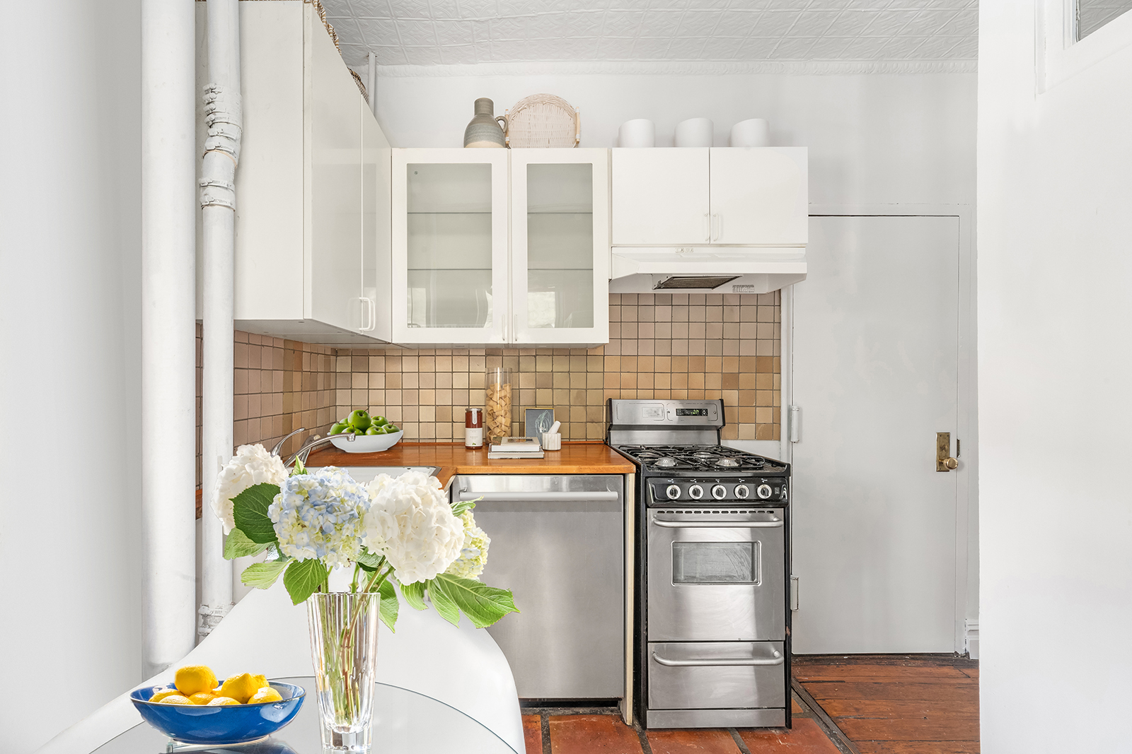 626 East 14th Street, Unit 8 Manhattan, NY 10009 - Photo 8 of 14 a kitchen with stainless steel appliances a stove a sink and a cabinets