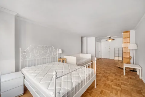 a bedroom with a bed and a table