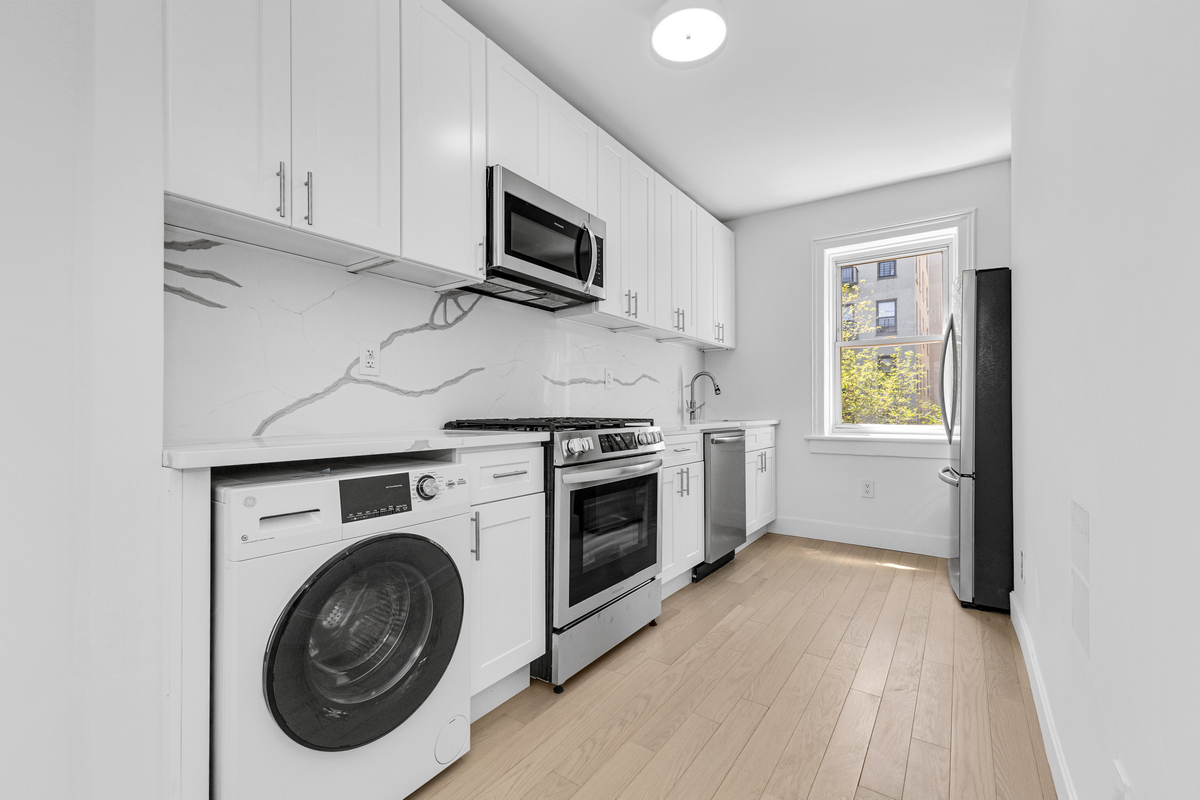 1050 Sterling Place Brooklyn, NY 11213 - Photo 17 of 23 a kitchen with a stove top oven and cabinets