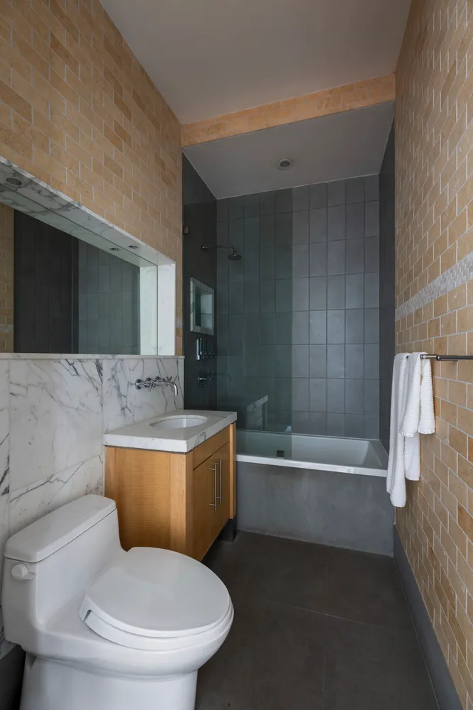 a bathroom with a sink a toilet and bathtub