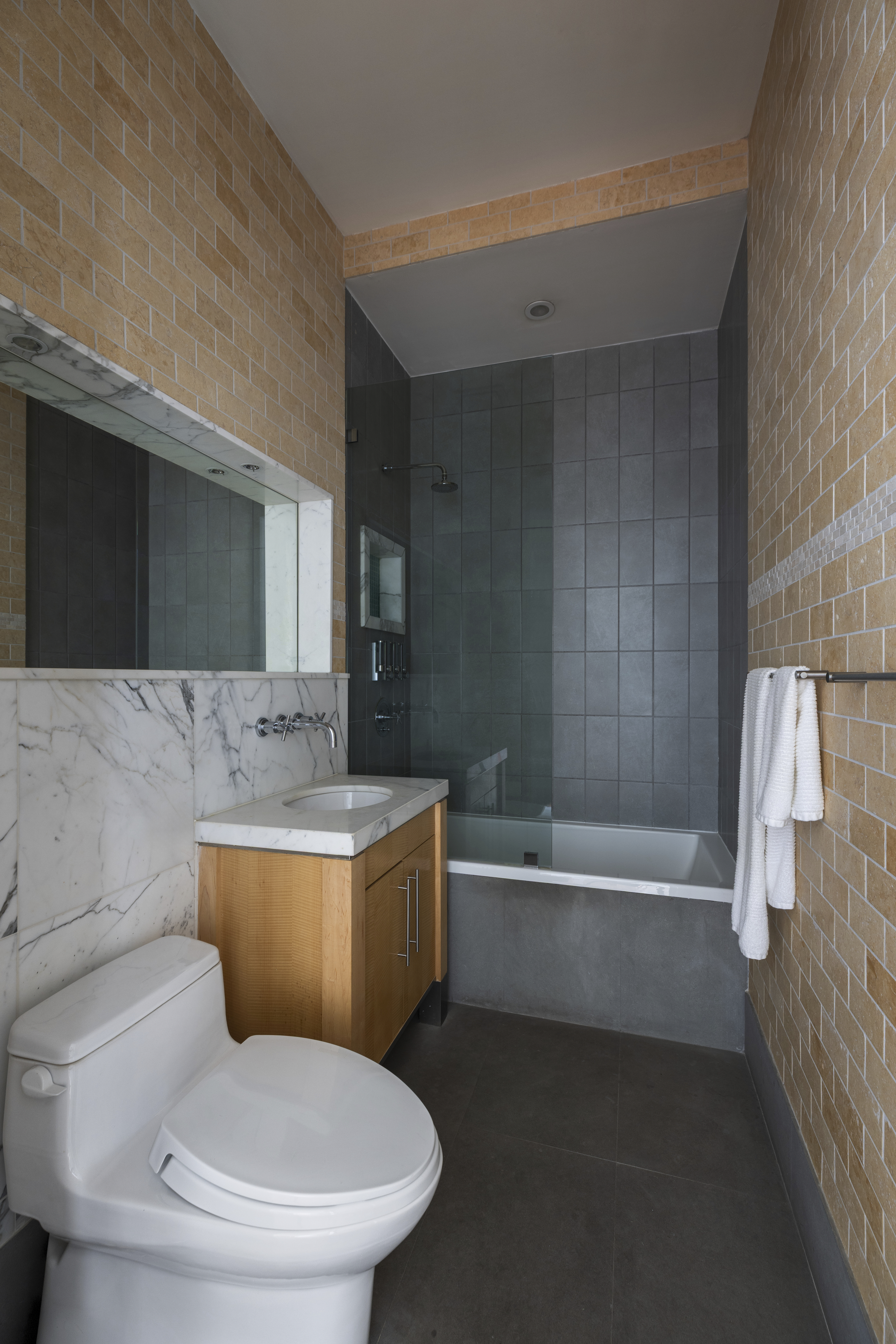 60 Broadway, Unit 8K Brooklyn, NY 11249 - Photo 8 of 10 a bathroom with a sink a toilet and bathtub