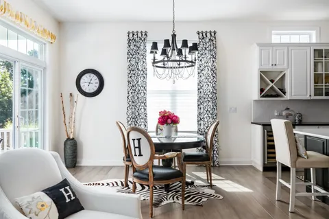 a living room with furniture a clock and a window