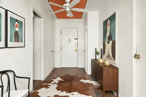 a view of a hallway with wooden floor and dining room