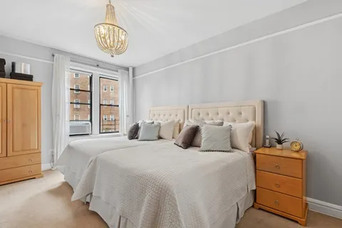 a bedroom with three beds and a window