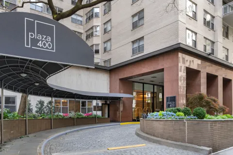 a front view of a building with a garden